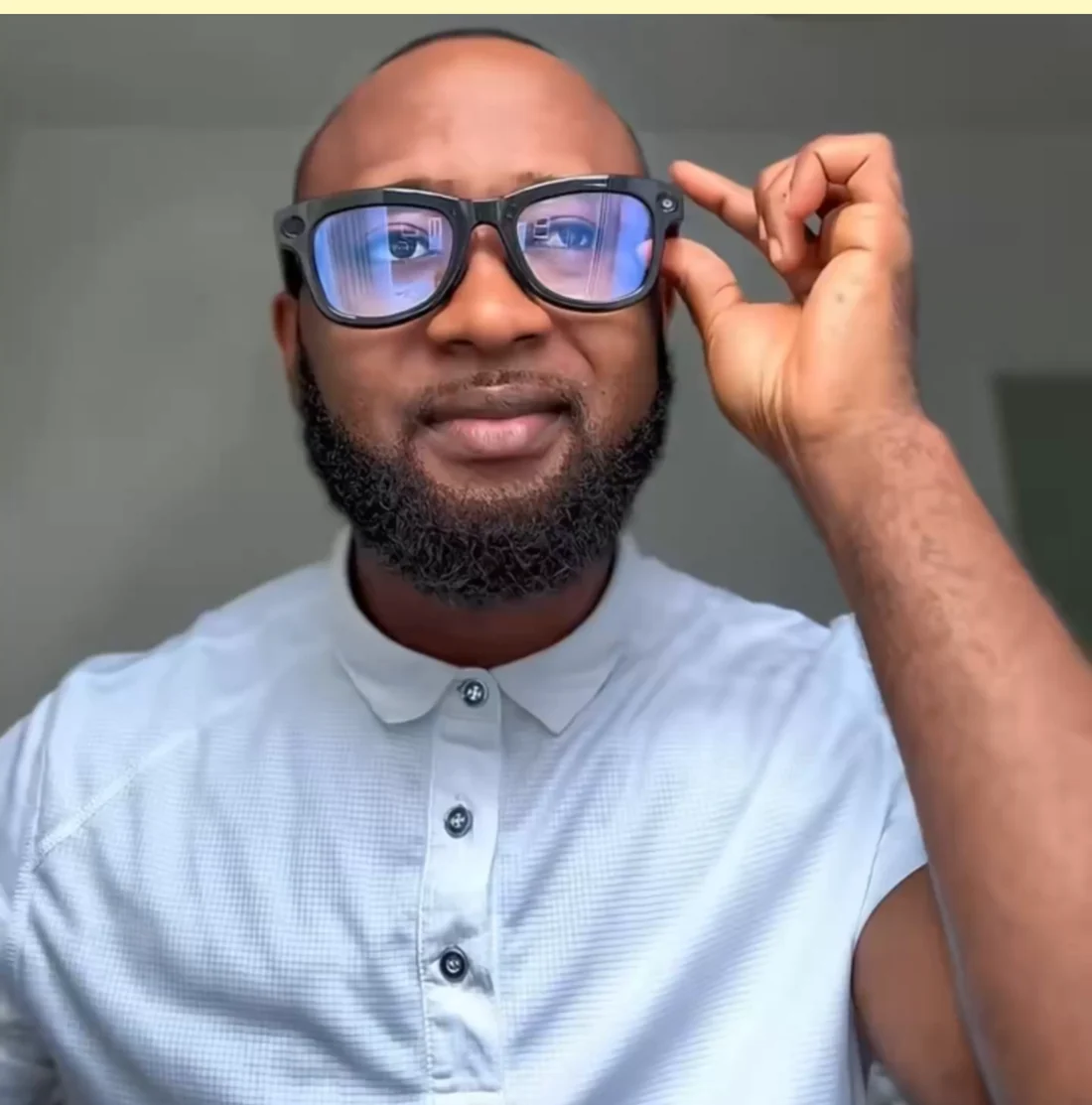 A man wearing Magira Glasses and touching the frame